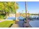 Beautiful waterfront property with direct lake access, tropical landscaping, and manicured lawn at 2552 S Playa --, Mesa, AZ 85202
