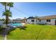Well-maintained backyard featuring a sparkling pool, lush grass, and mature landscaping at 2608 W Aster Dr, Phoenix, AZ 85029