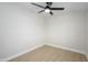 Bright bedroom featuring light wood flooring and a contemporary ceiling fan at 2608 W Aster Dr, Phoenix, AZ 85029