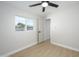 Bright bedroom with neutral walls, a modern ceiling fan, and a window at 2608 W Aster Dr, Phoenix, AZ 85029