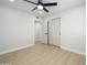 Bedroom features wood-look flooring and bright closet storage at 2608 W Aster Dr, Phoenix, AZ 85029