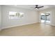 Bright living room with large windows and sliding glass door access to the backyard and patio at 2608 W Aster Dr, Phoenix, AZ 85029