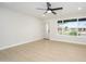 Bright room with large window, light wood flooring and modern ceiling fan at 2608 W Aster Dr, Phoenix, AZ 85029