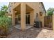 View of the gravel backyard featuring a covered patio and small shrubs at 2727 N Price Rd # 32, Chandler, AZ 85224