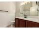 A secondary bathroom features a dark vanity, a neutral tile floor, and a tub and shower in the background at 2727 N Price Rd # 32, Chandler, AZ 85224