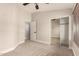 A well-lit bedroom boasts neutral carpet, an entrance door, and a mirrored closet with sliding doors at 2727 N Price Rd # 32, Chandler, AZ 85224