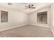 Bedroom featuring neutral carpet, ceiling fan, and two large windows at 2727 N Price Rd # 32, Chandler, AZ 85224