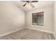 This bedroom features neutral carpet, a fan and overhead light, and a window with blinds at 2727 N Price Rd # 32, Chandler, AZ 85224