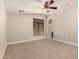 Large bedroom with neutral carpet, ceiling fan, and a large window at 2727 N Price Rd # 32, Chandler, AZ 85224
