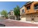 Exterior view of townhomes with two-car garages, showcasing the neighborhood's aesthetic and curb appeal at 2727 N Price Rd # 32, Chandler, AZ 85224
