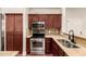 Kitchen featuring stainless steel appliances, granite countertops, and dark wood cabinetry at 2727 N Price Rd # 32, Chandler, AZ 85224