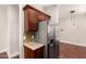 Modern kitchen featuring stainless steel refrigerator and dark wood cabinets at 2727 N Price Rd # 32, Chandler, AZ 85224