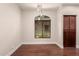 A well-lit dining room with wood flooring, modern lighting, and a view through a window at 2727 N Price Rd # 32, Chandler, AZ 85224