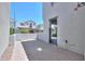 View of a brick-paved backyard featuring a metal gate and white perimeter wall at 281 E Shamrock Dr, Chandler, AZ 85286