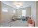 Cozy Bedroom with white crib, soft carpeting, and ample natural light from the window at 281 E Shamrock Dr, Chandler, AZ 85286