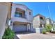 Exterior elevation of a modern home with a second-story balcony and a brick driveway at 281 E Shamrock Dr, Chandler, AZ 85286