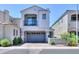 Contemporary two-story home featuring a balcony, a two-car garage, and desert landscaping at 281 E Shamrock Dr, Chandler, AZ 85286