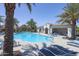 Community pool with lounge chairs, palm trees and shade structures to relax and enjoy the outdoors at 281 E Shamrock Dr, Chandler, AZ 85286