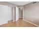 View of an empty bedroom with neutral walls, wood floors, and a closet at 2986 N Oregon St # 7, Chandler, AZ 85225