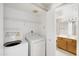 Laundry room with white washer and dryer units next to a bathroom at 2986 N Oregon St # 7, Chandler, AZ 85225
