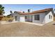 A large, gravel backyard with patio and exterior view of the home at 3021 E Harmony Cir, Mesa, AZ 85204