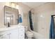 This well-lit bathroom includes a shower/tub combo and an elegant vanity at 3021 E Harmony Cir, Mesa, AZ 85204
