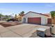 Charming single-story home featuring a well-manicured yard with unique rock landscaping and a two car garage at 3021 E Harmony Cir, Mesa, AZ 85204