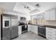 Well-equipped kitchen featuring stainless steel appliances, white cabinets, and modern fixtures, enhancing functionality at 3021 E Harmony Cir, Mesa, AZ 85204