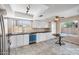 Modern kitchen featuring white cabinets, stainless steel appliances, and tile flooring at 3021 E Harmony Cir, Mesa, AZ 85204