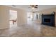 Spacious living room view to dining area and kitchen with neutral-toned walls, fireplace, and window at 3021 E Harmony Cir, Mesa, AZ 85204