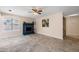 Spacious living room features neutral-toned walls, a fireplace, and a window at 3021 E Harmony Cir, Mesa, AZ 85204