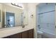 Bathroom features a vanity with dark wood cabinets and a sink, plus a shower/tub combo at 3451 S Wren Dr, Gilbert, AZ 85297