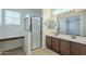 Well-lit bathroom boasts double sinks, tile floors, makeup counter, and glass-enclosed shower at 3451 S Wren Dr, Gilbert, AZ 85297
