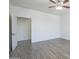 Bright bedroom with ensuite access, showcasing neutral walls, wood-look floors, and ceiling fan at 3451 S Wren Dr, Gilbert, AZ 85297