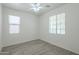 Bedroom featuring two windows and neutral walls complemented by a ceiling fan at 3451 S Wren Dr, Gilbert, AZ 85297