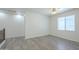 Bright bedroom features a ceiling fan, wood-look floors, and a window for natural light at 3451 S Wren Dr, Gilbert, AZ 85297