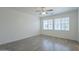 Well-lit bedroom boasts neutral walls, wood-look flooring, and two windows for natural light at 3451 S Wren Dr, Gilbert, AZ 85297