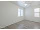 Bedroom featuring two windows, a ceiling fan, and light-colored flooring at 3451 S Wren Dr, Gilbert, AZ 85297