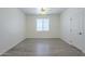 Clean bedroom with wood-look floors, white door, and ample natural light from the window at 3451 S Wren Dr, Gilbert, AZ 85297