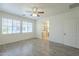 Comfortable bedroom with wood-look floors, ceiling fan, and ensuite bath featuring glass shower at 3451 S Wren Dr, Gilbert, AZ 85297