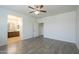 Inviting bedroom with bathroom access, wood-look floors, neutral walls, and ceiling fan at 3451 S Wren Dr, Gilbert, AZ 85297