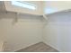 Bright, walk-in closet featuring white walls, shelving, and a small, high window for natural light at 3451 S Wren Dr, Gilbert, AZ 85297