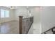Upstairs hallway and landing featuring laminate flooring, wrought iron banister and lots of natural light at 3451 S Wren Dr, Gilbert, AZ 85297