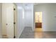 Hallway with light flooring and trim leading to an adjacent bathroom at 3451 S Wren Dr, Gilbert, AZ 85297