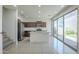 Open concept kitchen with island, stainless appliances, and sliding glass doors to backyard at 3451 S Wren Dr, Gilbert, AZ 85297