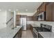 Modern kitchen with stainless steel appliances, granite countertops, and tile flooring at 3451 S Wren Dr, Gilbert, AZ 85297