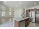 Bright open concept kitchen with stainless steel appliances, island and tile floors at 3451 S Wren Dr, Gilbert, AZ 85297