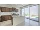 Well-lit kitchen with stainless steel appliances, island and sliding glass door to backyard at 3451 S Wren Dr, Gilbert, AZ 85297
