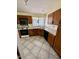 Kitchen with oak cabinets, a white countertop, and white appliances against a tile floor at 3510 E Hampton Ave # 133, Mesa, AZ 85204