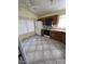Open kitchen layout featuring light oak cabinets, an electric range, and white appliances on tile floor at 3510 E Hampton Ave # 133, Mesa, AZ 85204